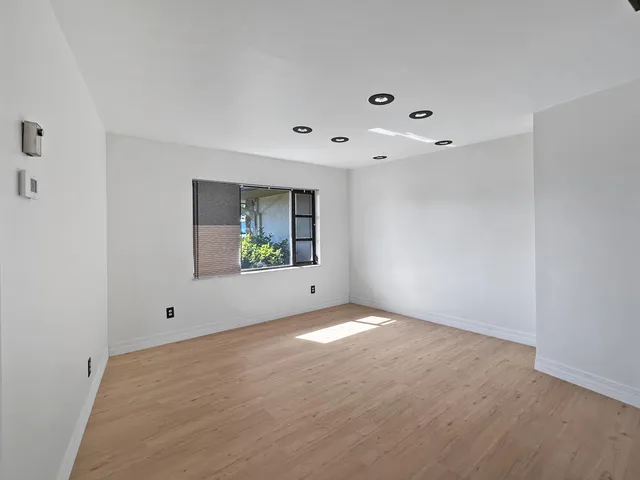a view of a dining room with furniture and a potted plant