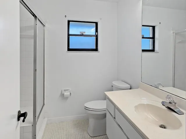 an empty room with closet and wooden floor