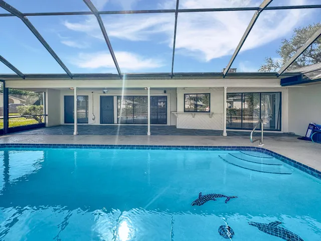 a view of a house with a backyard