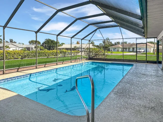 a swimming pool with outdoor seating