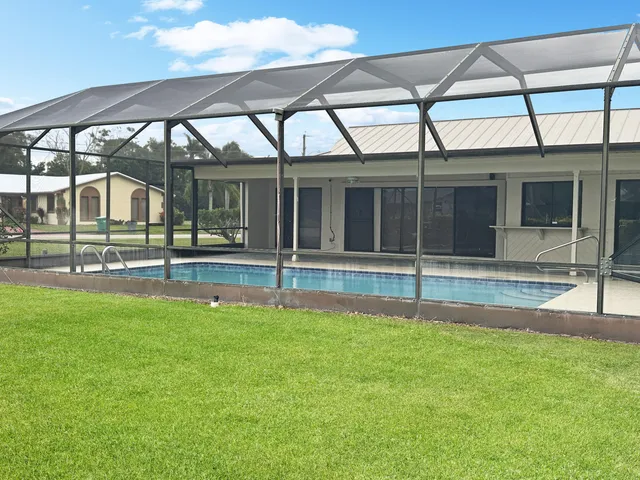 a view of a house with a yard and sitting area