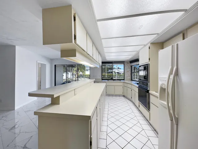 a kitchen with refrigerator and window