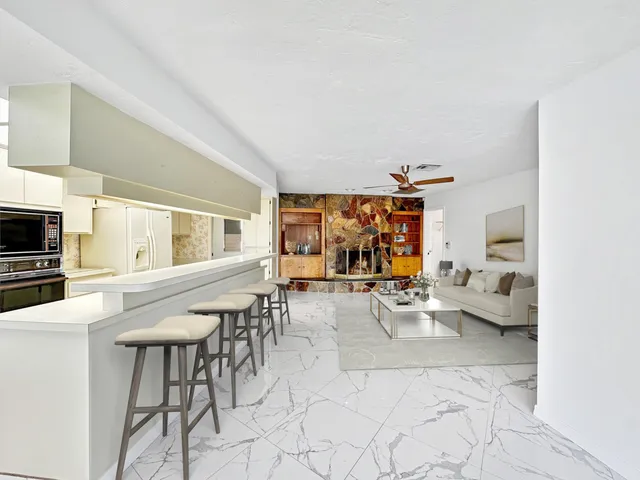 a view of kitchen with furniture and refrigerator