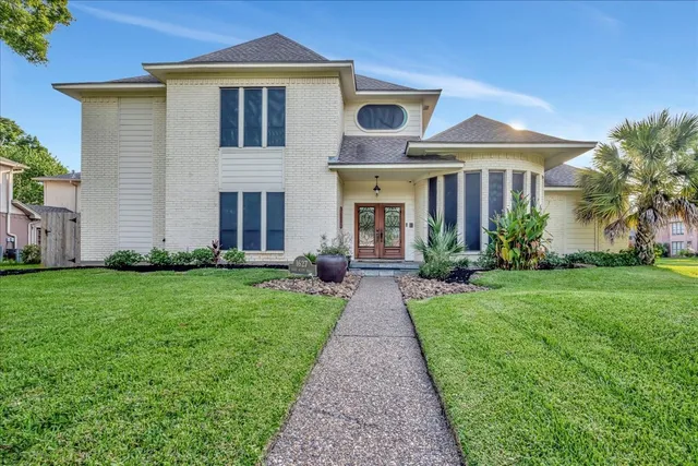 a front view of a house with garden