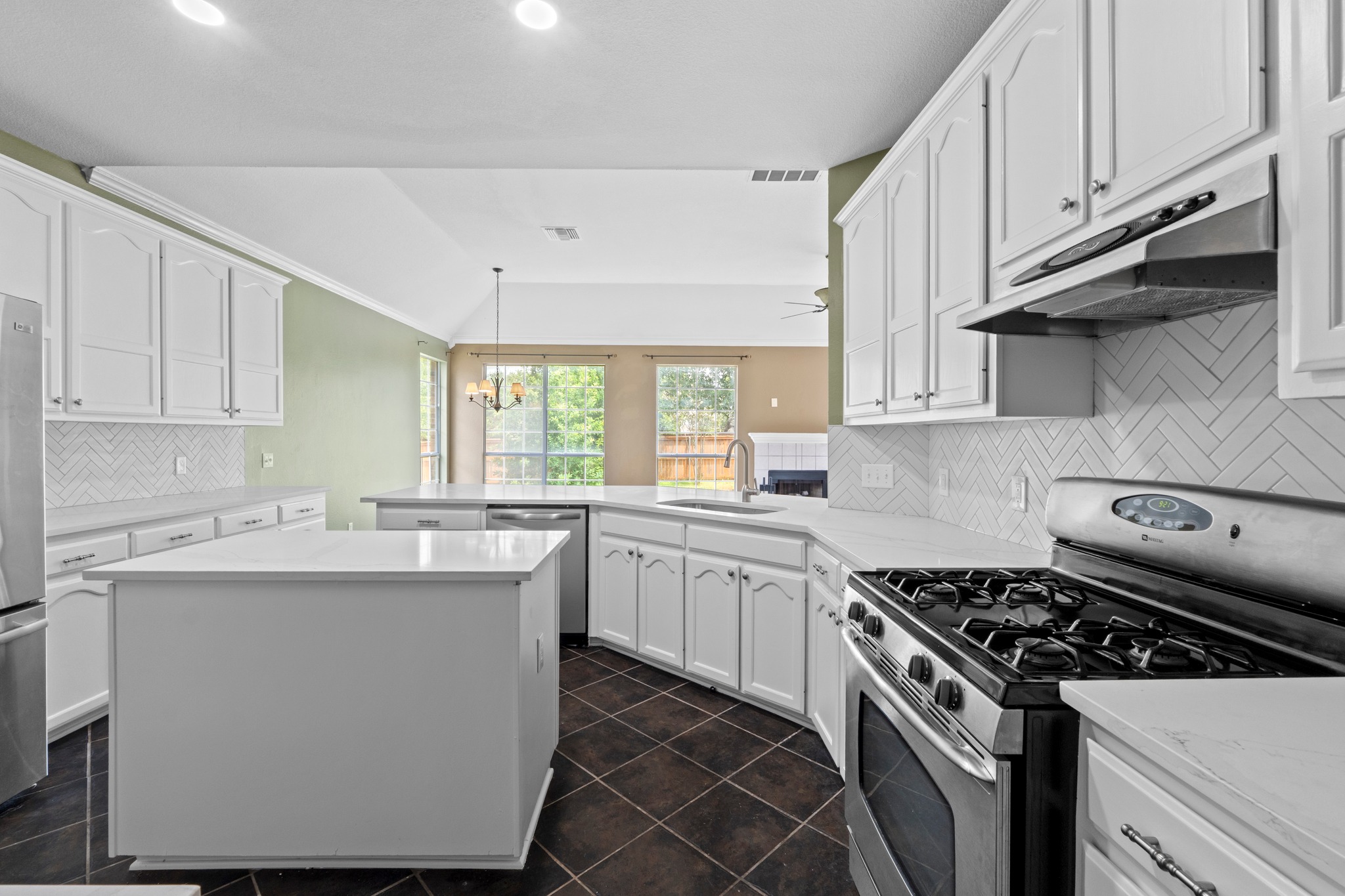 8605 Axis Drive Austin, TX 78749 - Photo 16 of 38 An inviting kitchen with white cabinetry, sleek countertops, and modern stainless steel appliances.
