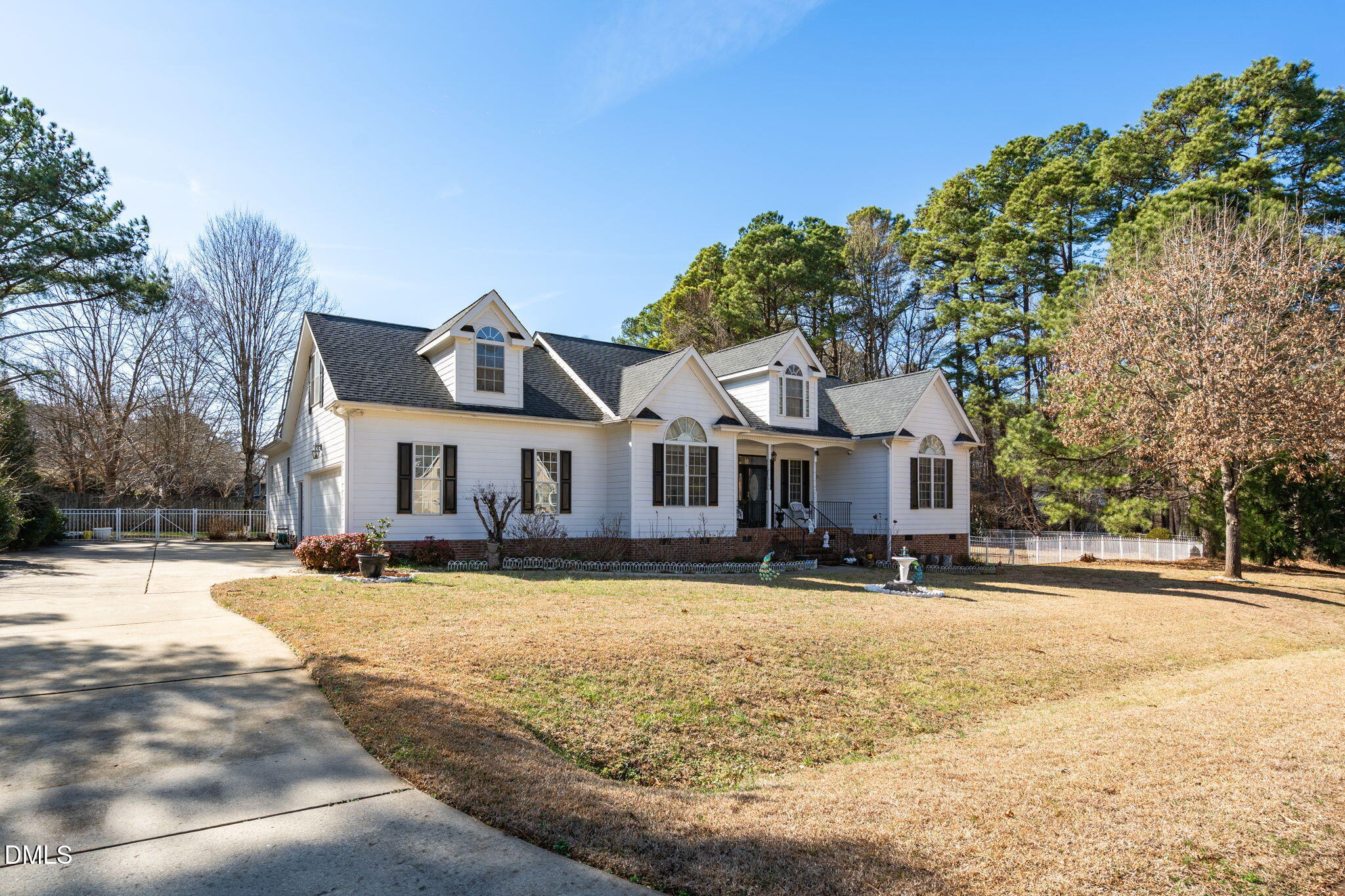 7605 Double E Court Raleigh, NC 27613 - Photo 8 of 49 a front view of a house with a yard covered with snow and trees