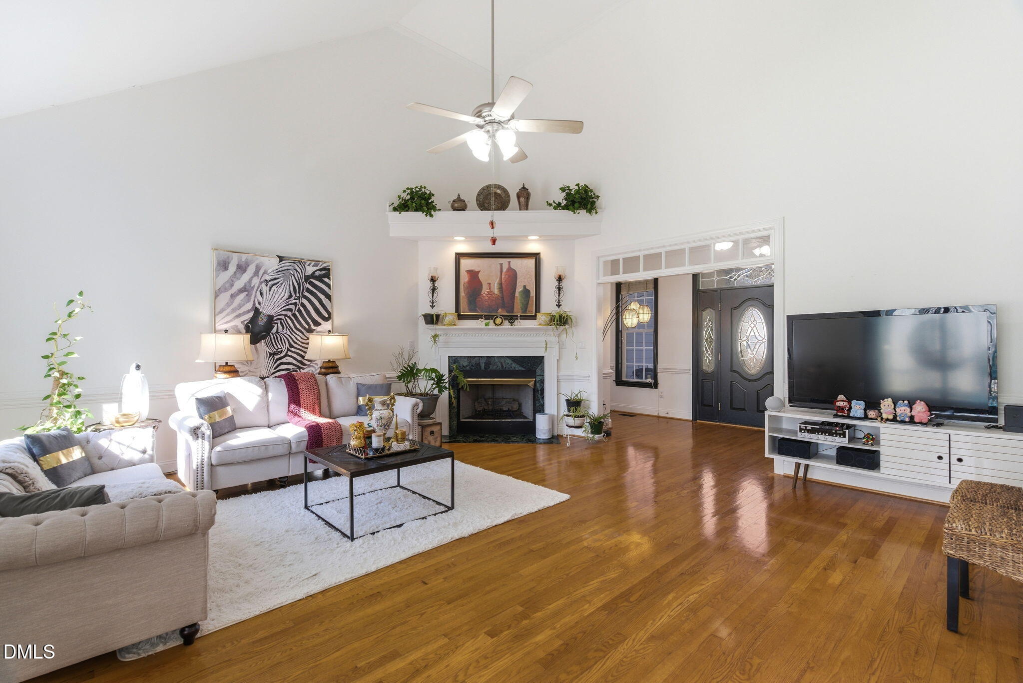7605 Double E Court Raleigh, NC 27613 - Photo 10 of 49 a living room with furniture a fireplace and a flat screen tv