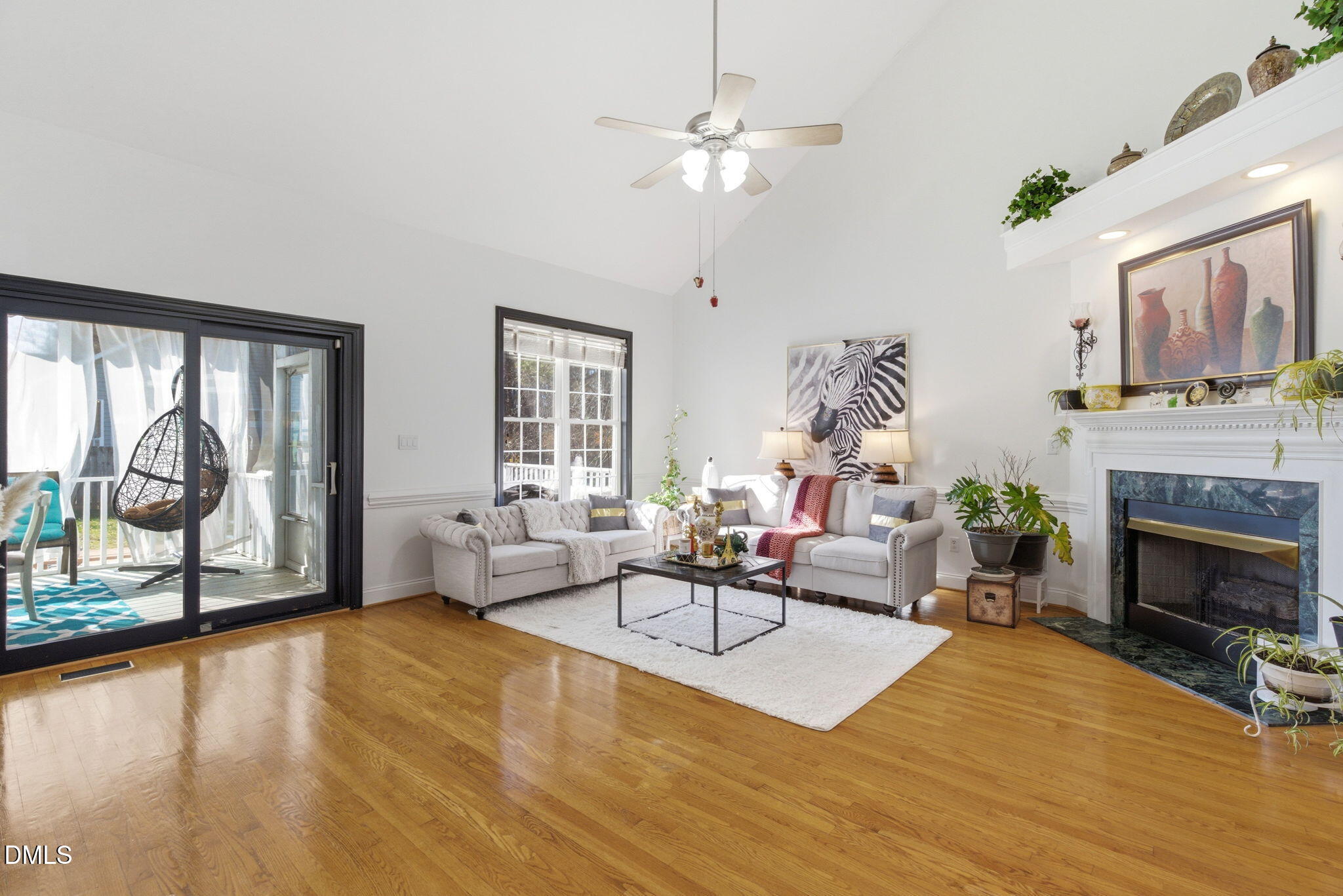 7605 Double E Court Raleigh, NC 27613 - Photo 13 of 49 a living room with furniture a fireplace and a large window with balcony view