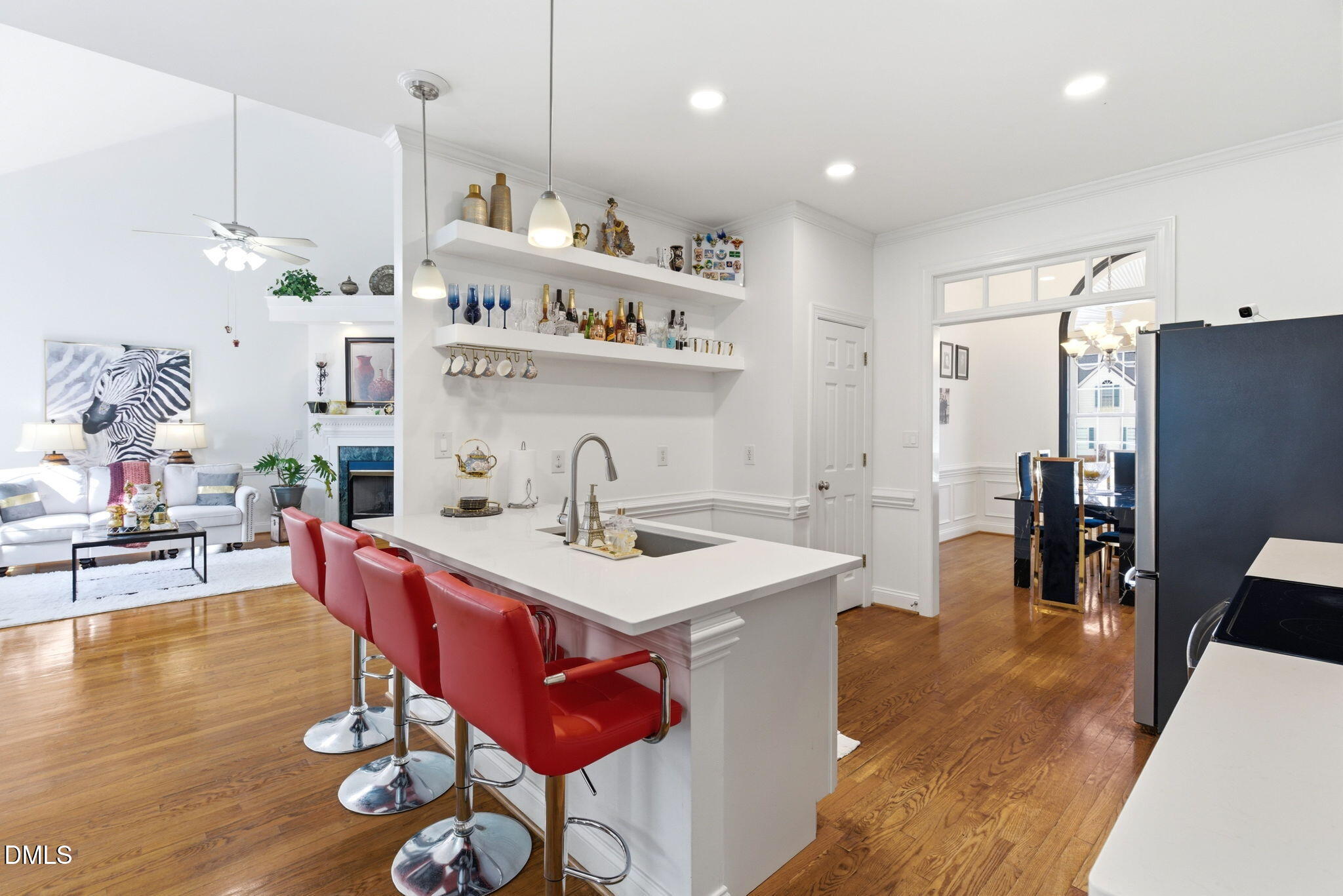 7605 Double E Court Raleigh, NC 27613 - Photo 16 of 49 a kitchen with stainless steel appliances kitchen island granite countertop a sink a stove a dining table and chairs with wooden floor