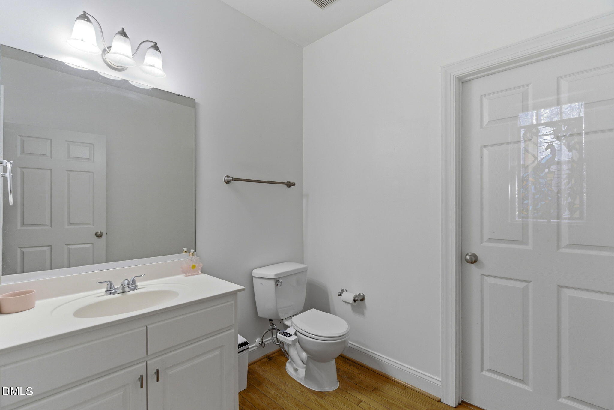7605 Double E Court Raleigh, NC 27613 - Photo 19 of 49 a bathroom with a toilet sink and mirror