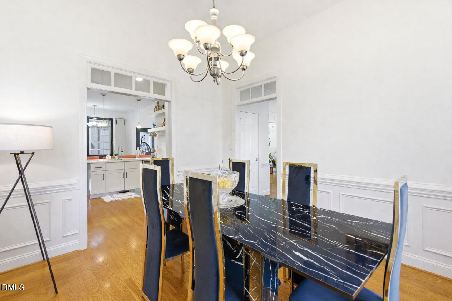 7605 Double E Court Raleigh, NC 27613 - Photo 22 of 49 a view of a dining room with furniture and a chandelier