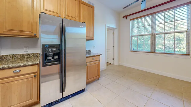 a kitchen with stainless steel appliances granite countertop a refrigerator and a stove