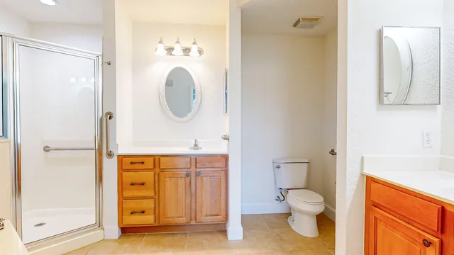 a bathroom with a toilet a sink and shower