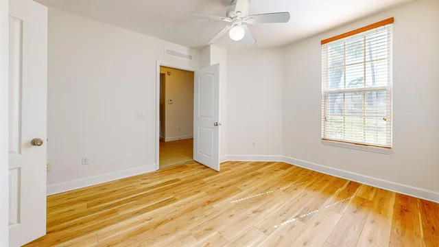 wooden floor in an empty room with a window