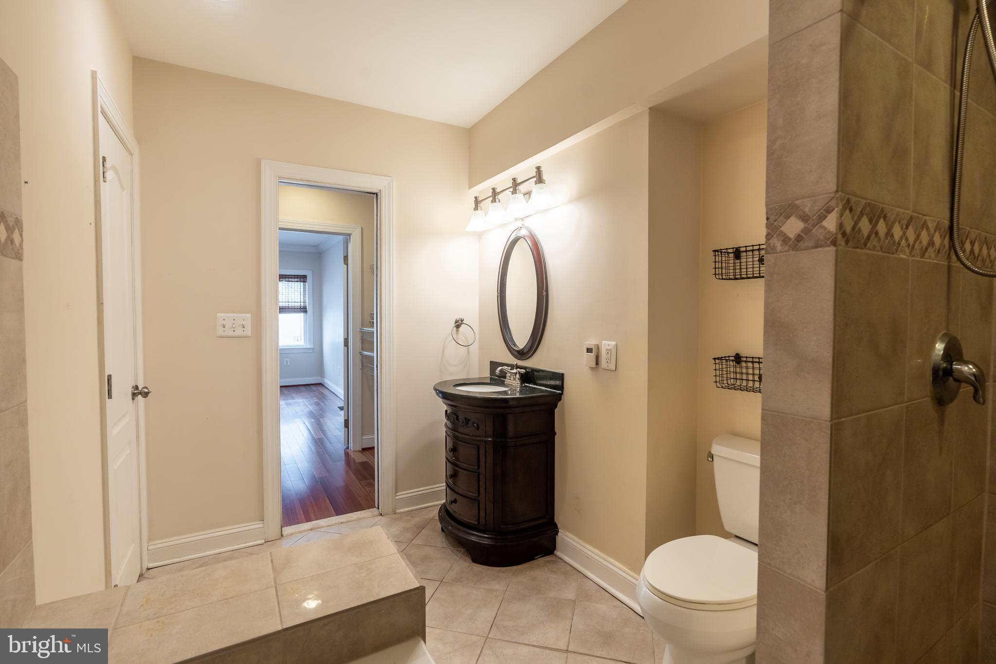 106 West Cross Street Baltimore, MD 21230 - Photo 18 of 41 a bathroom with a toilet and a shower