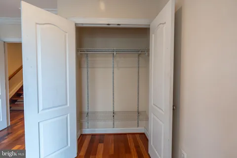 a view of walk in closet with empty room