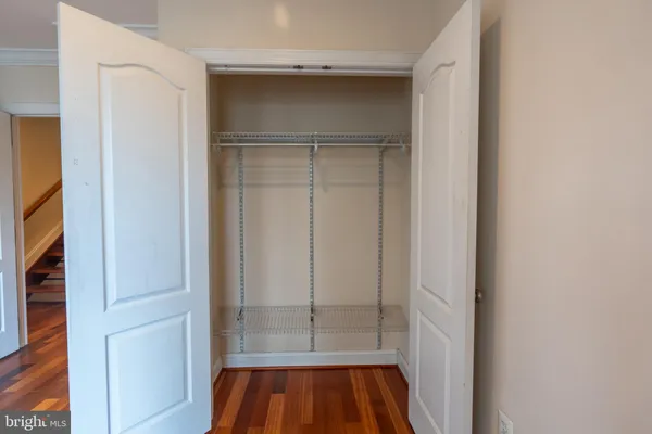 a view of walk in closet with empty room
