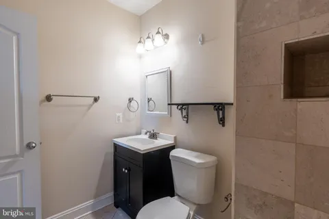 a bathroom with a toilet sink and mirror