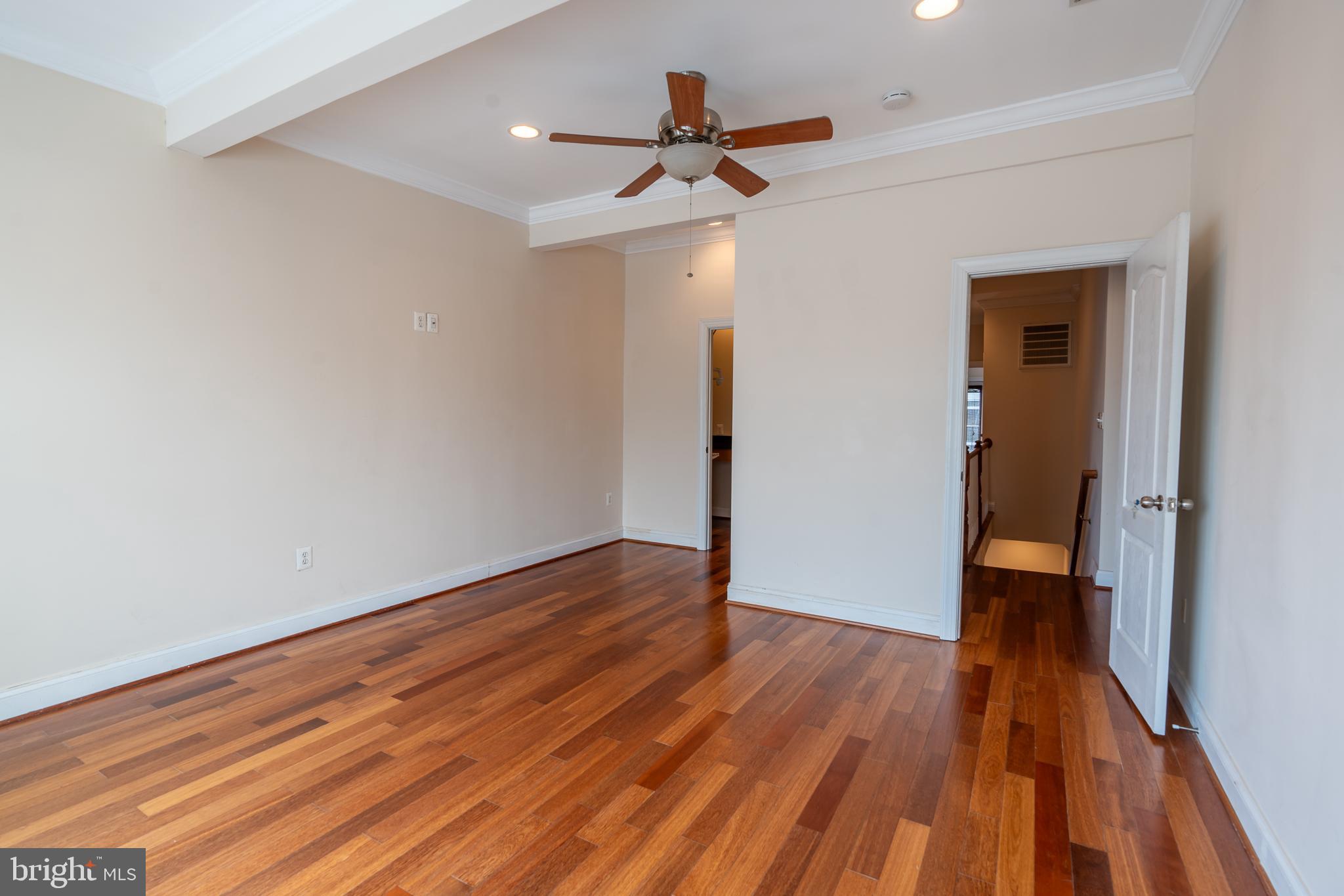 106 West Cross Street Baltimore, MD 21230 - Photo 29 of 41 a view of a room with wooden floor and a ceiling fan