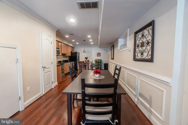 a dining room with furniture and wooden floor