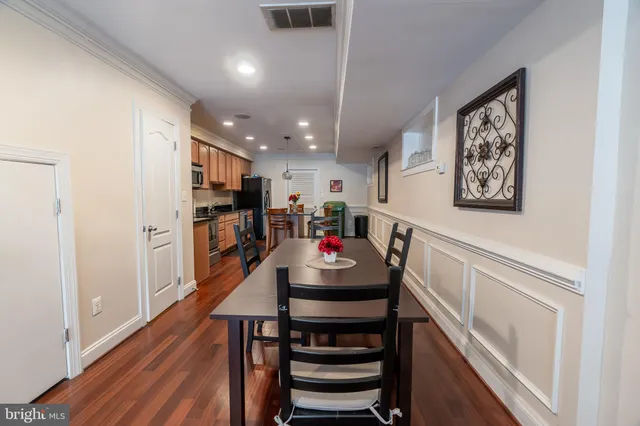 a dining room with furniture and wooden floor
