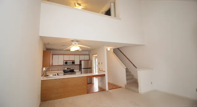 a view of living room with furniture and ceiling fan