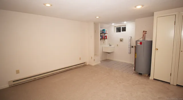a view of a storage & utility room with a fridge