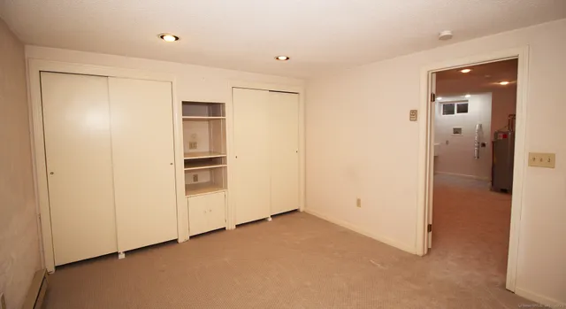 a view of an empty room with cabinet