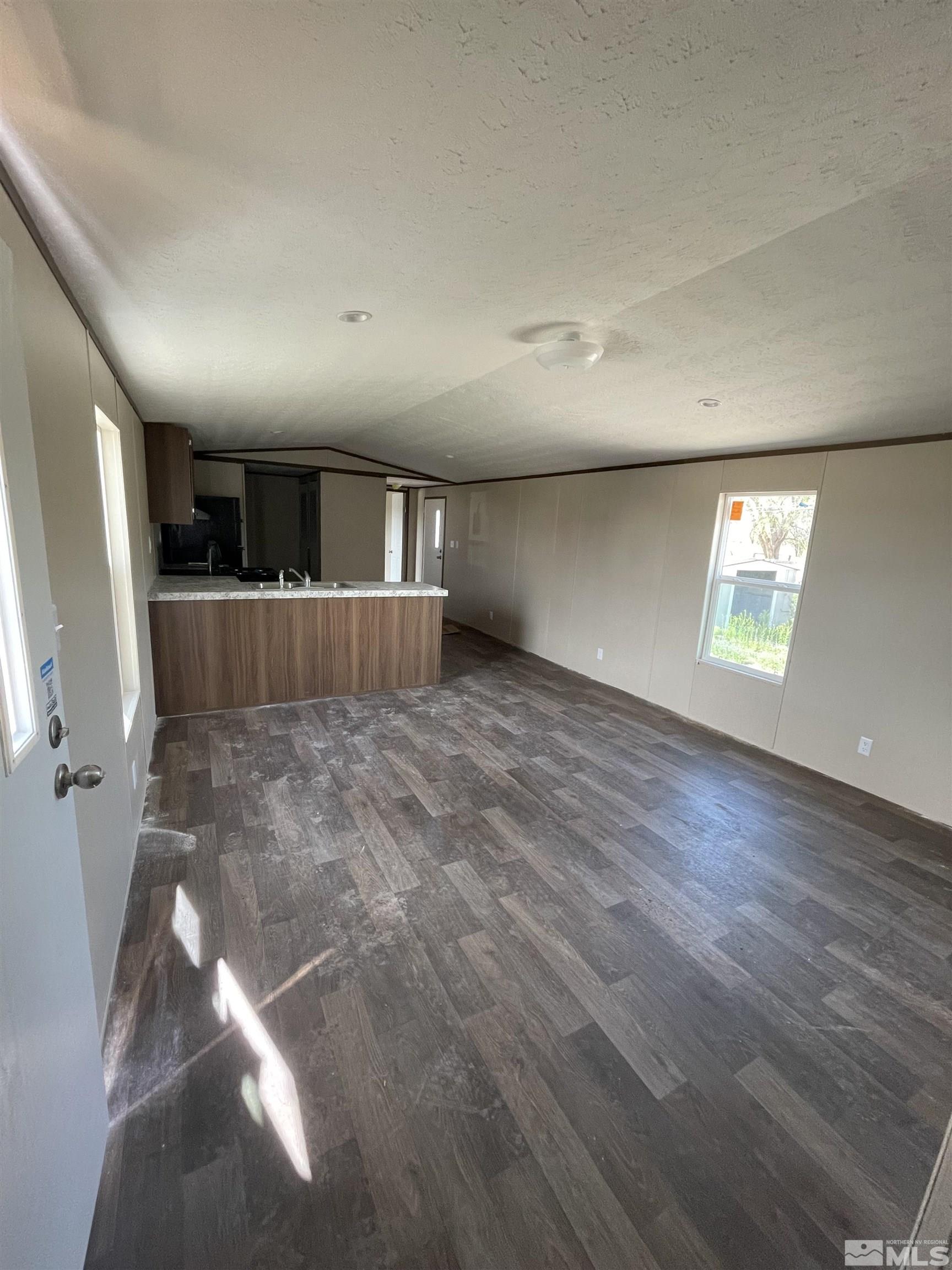 2000 Auction Road, Unit 6 Fallon, NV 89406 - Photo 3 of 7 wooden floor in an empty room with a window