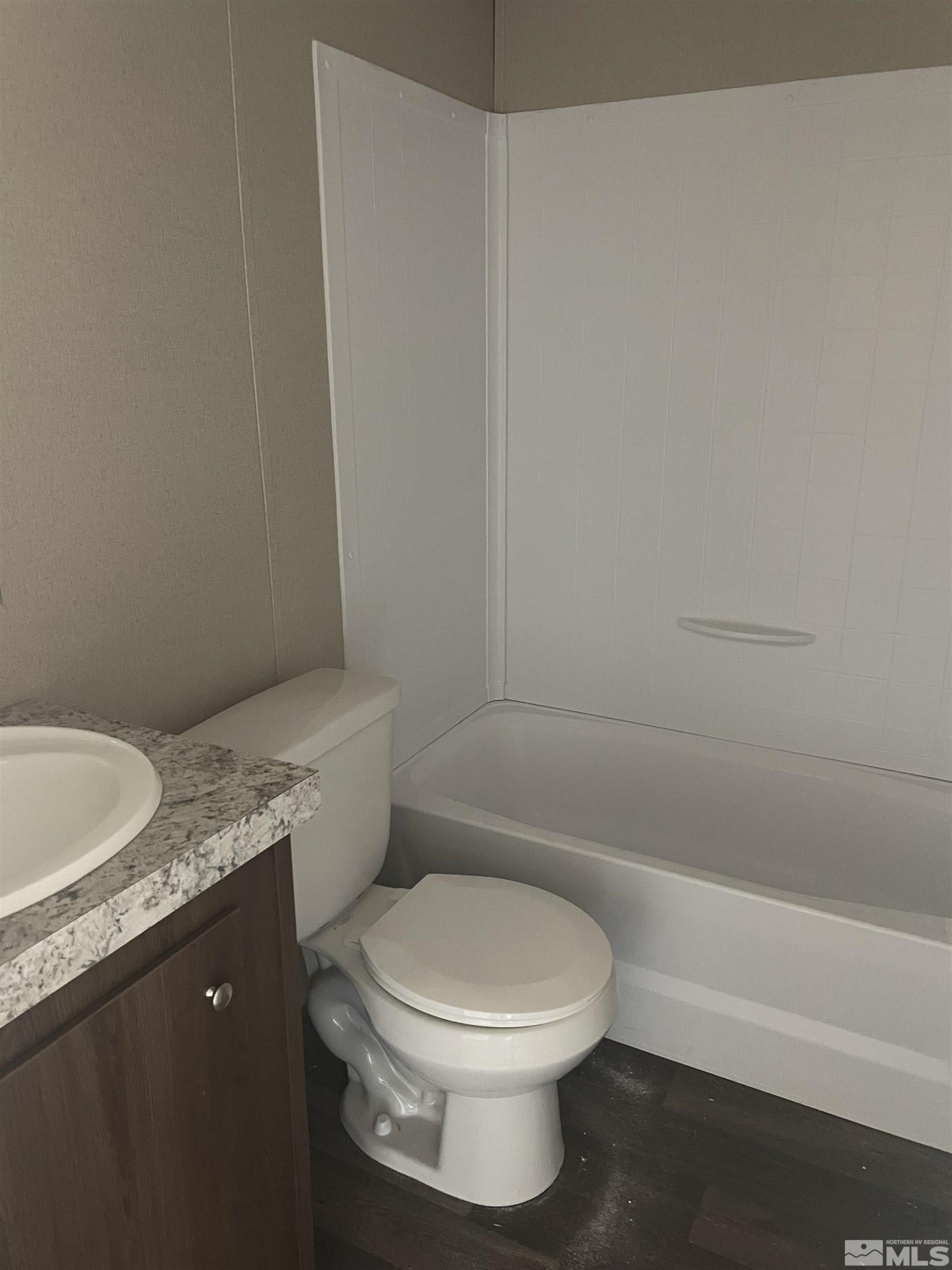 2000 Auction Road, Unit 6 Fallon, NV 89406 - Photo 6 of 7 a bathroom with a granite countertop toilet and a bathtub