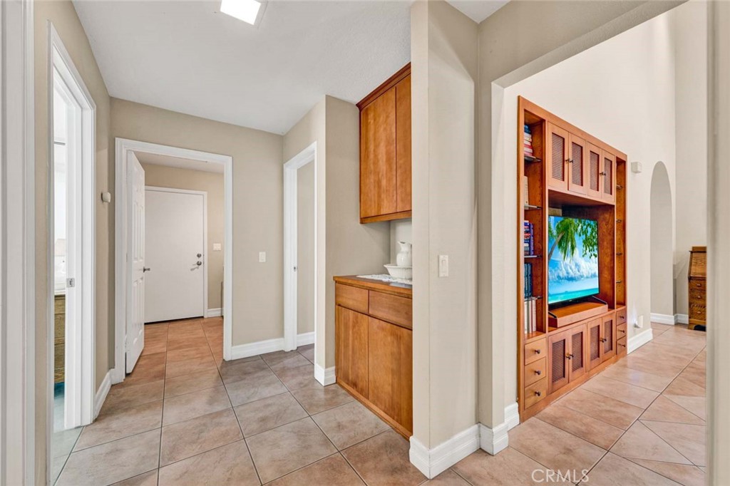 7710 East Strawberry Ridge Orange, CA 92869 - Photo 27 of 33 Hallway leading to laundry room and attached garage. Picture on TV screen was digitally added.