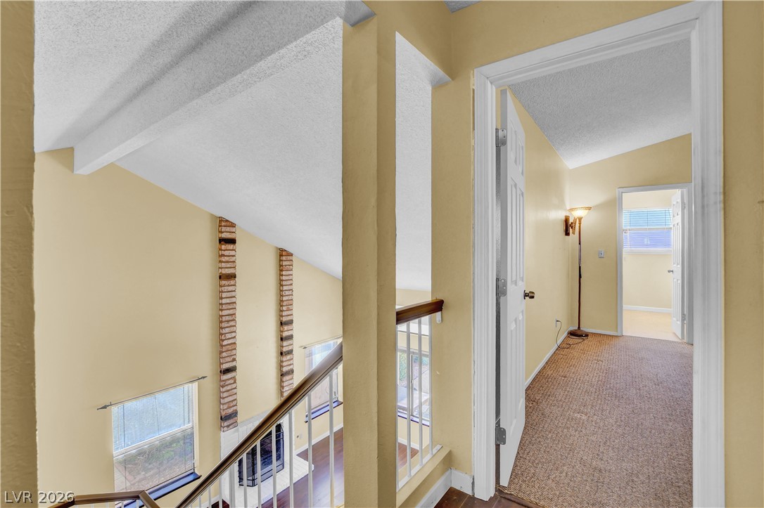 6440 Hartwood Road Las Vegas, NV 89108 - Photo 26 of 59 Angled ceilings and exposed brick accents frame this inviting split-level entryway.