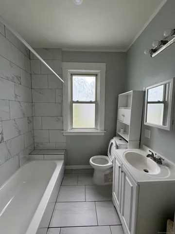 a bathroom with a sink toilet and bathtub