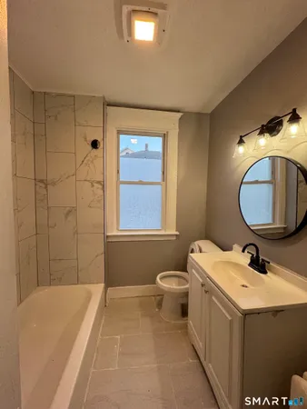 a bathroom with a sink a toilet and mirror
