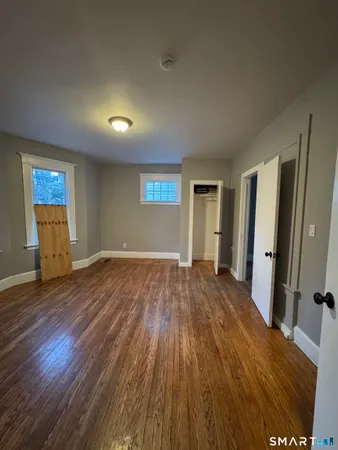 a view of a room with wooden floor and window