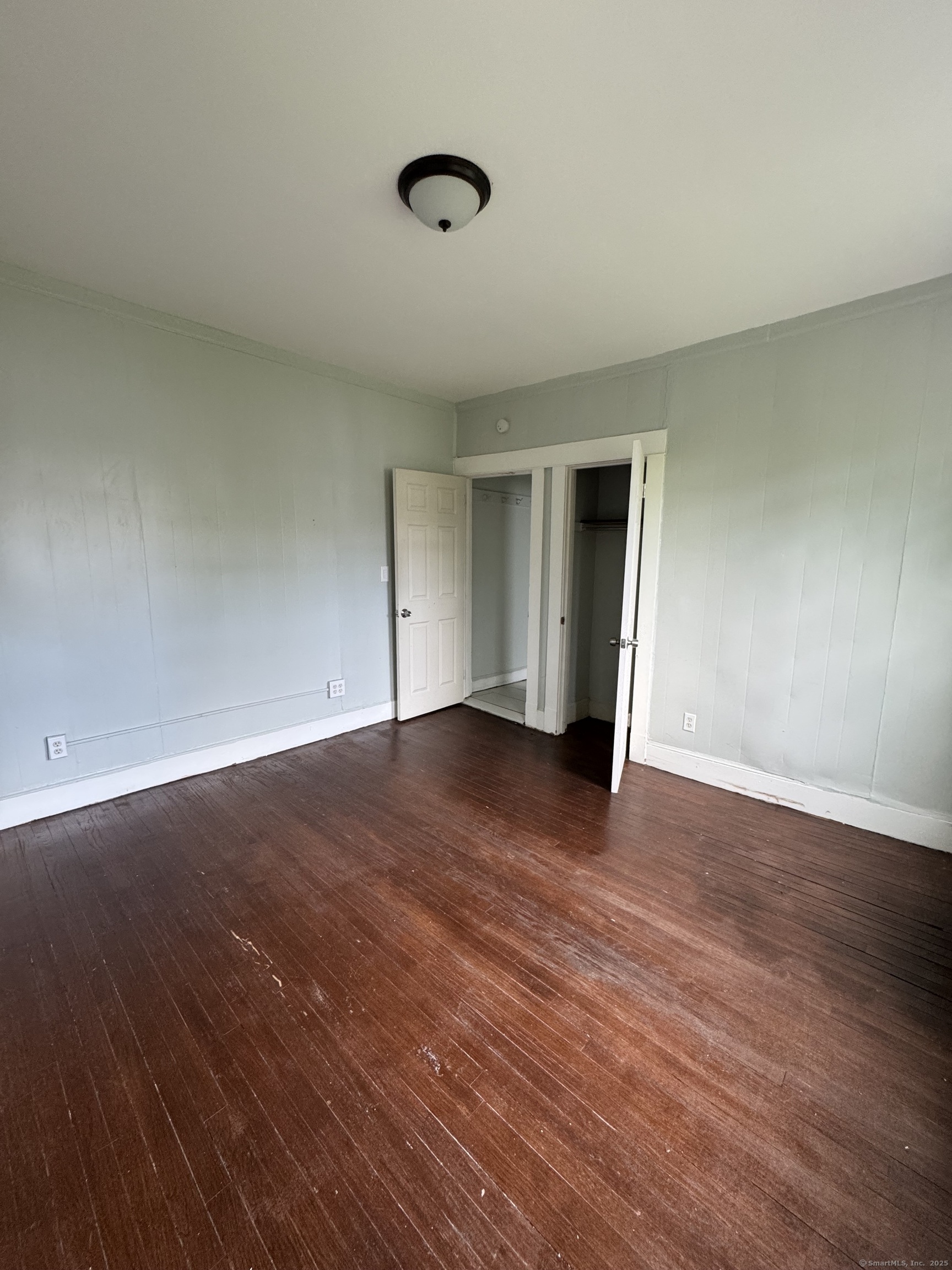 916 Winchester Avenue, Unit 1 New Haven, CT 06511 - Photo 9 of 10 a view of empty room with wooden floor and fan