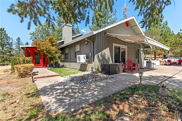 a view of a house with a yard and tree s