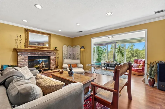 a living room with furniture fireplace and a large window