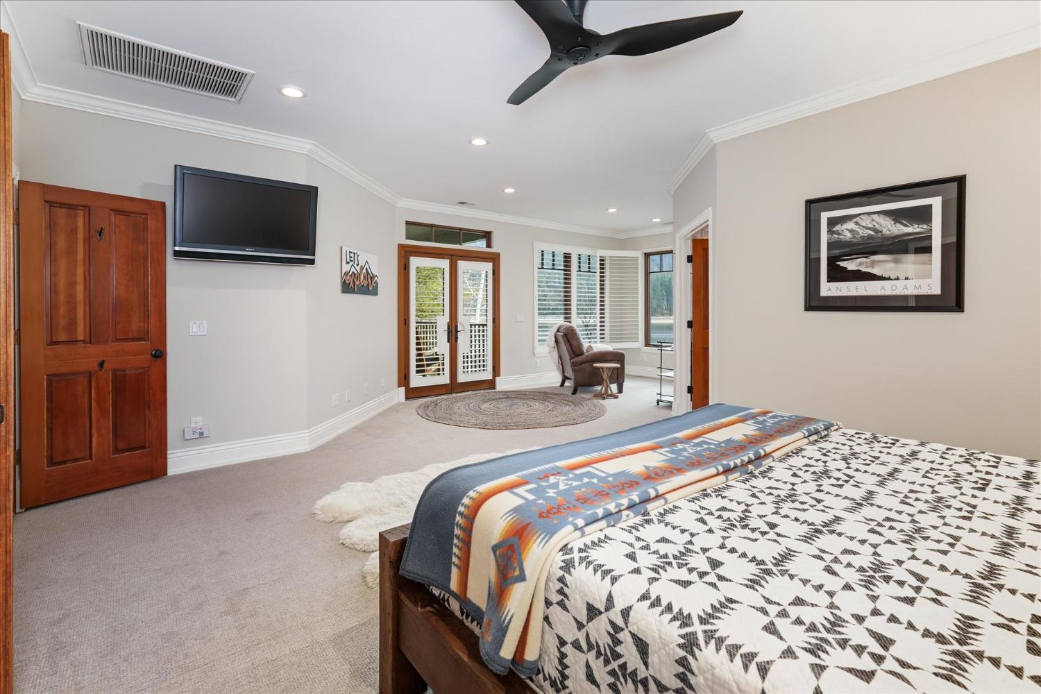 39290 Point Bass Lake, CA 93604 - Photo 17 of 80 a spacious bedroom with a bed and a flat screen tv