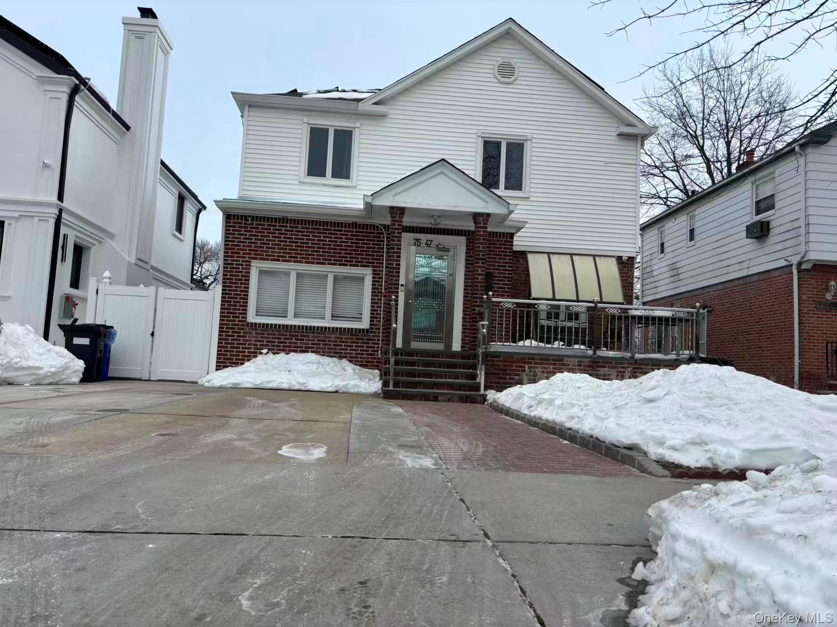 75-47 193rd Street Queens, NY 11366 - Photo 1 of 27 a front view of a house with a yard and garage