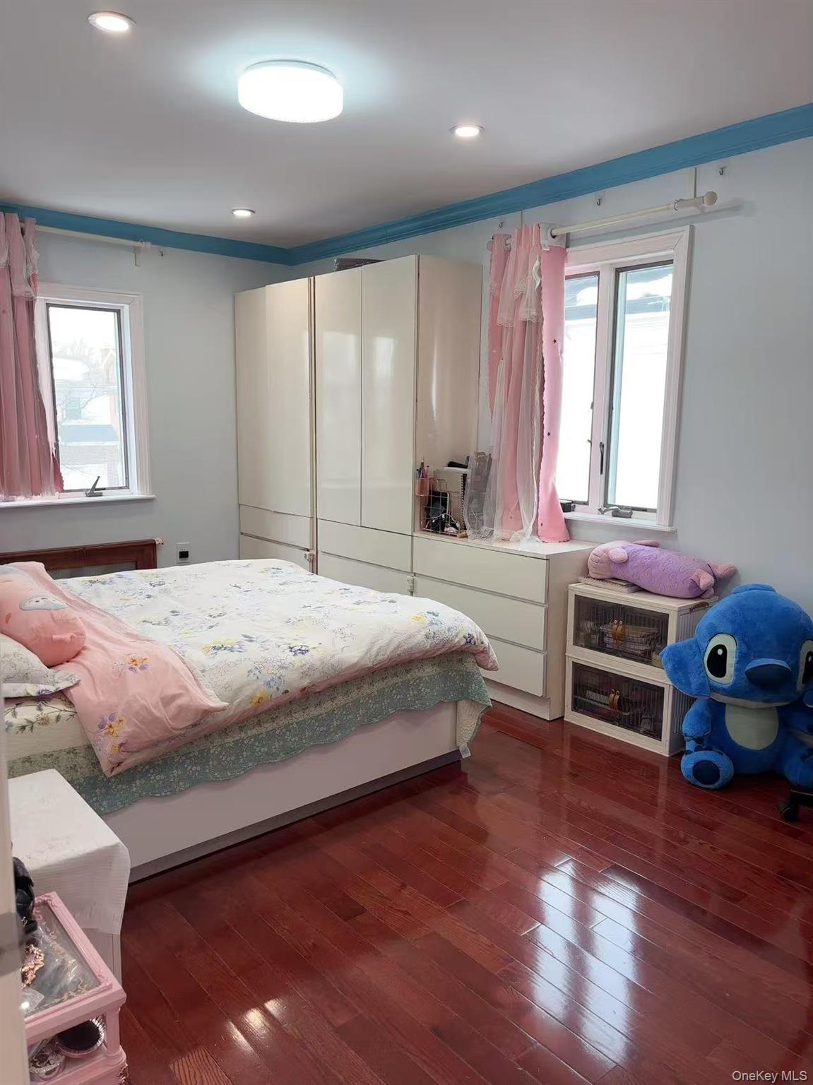 75-47 193rd Street Queens, NY 11366 - Photo 14 of 27 a bedroom with a bed and a window