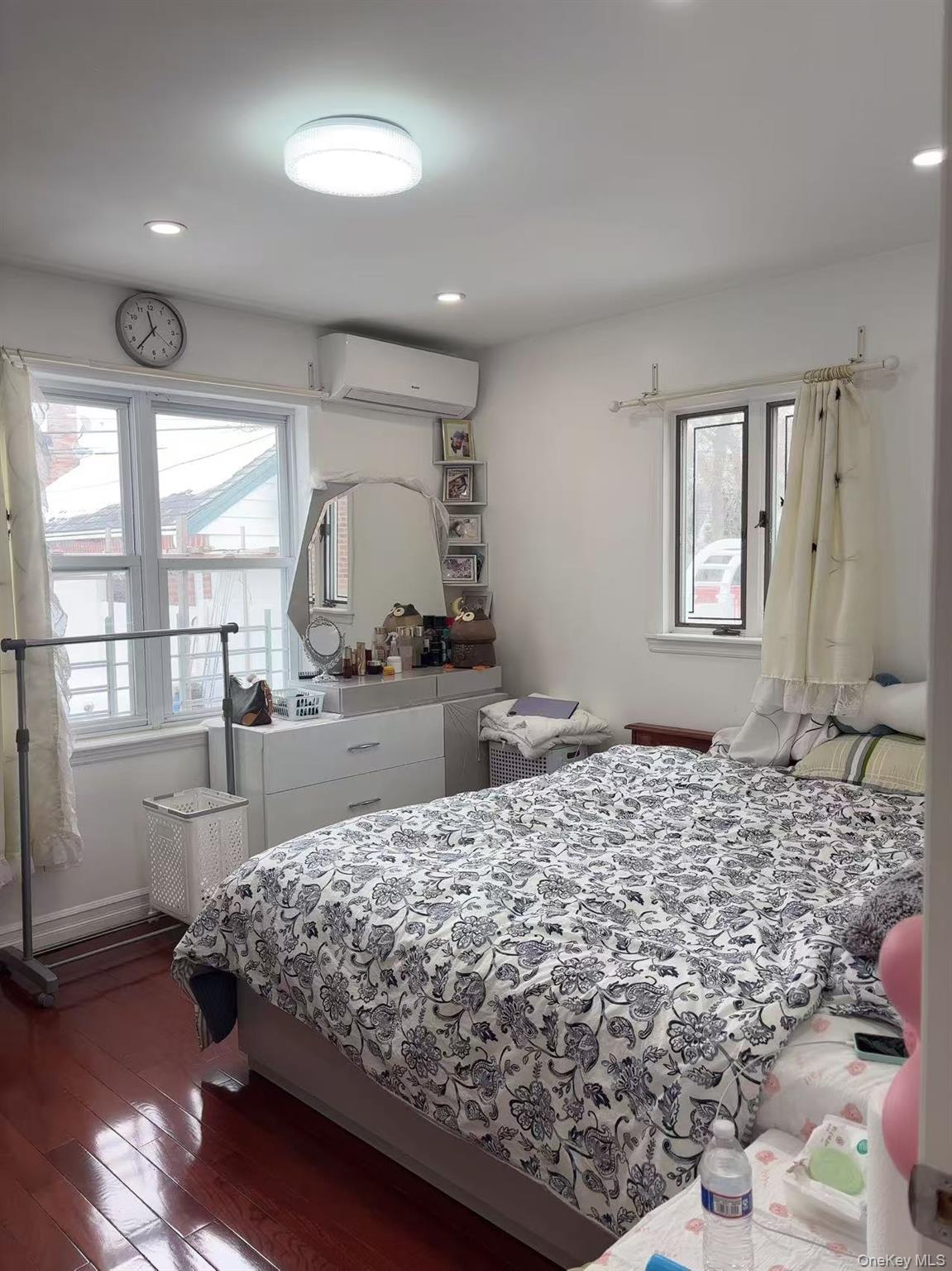 75-47 193rd Street Queens, NY 11366 - Photo 16 of 27 a bed sitting in a spacious bedroom next to a window
