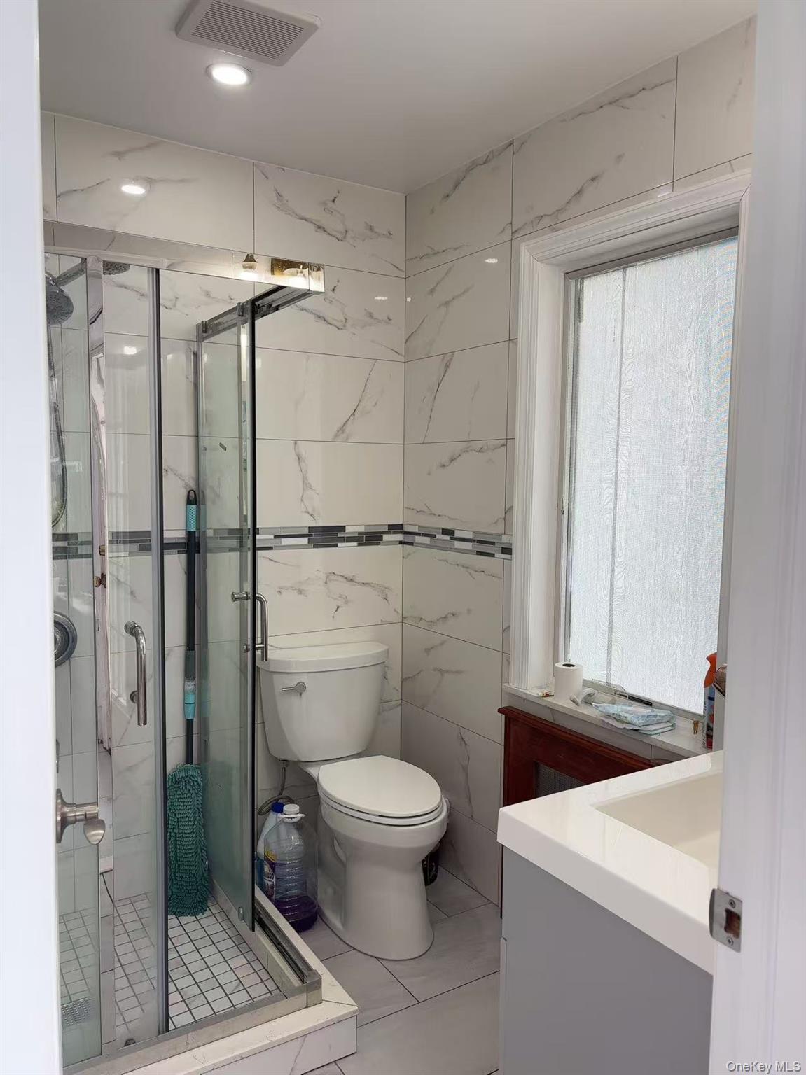 75-47 193rd Street Queens, NY 11366 - Photo 18 of 27 a bathroom with a toilet a sink and shower