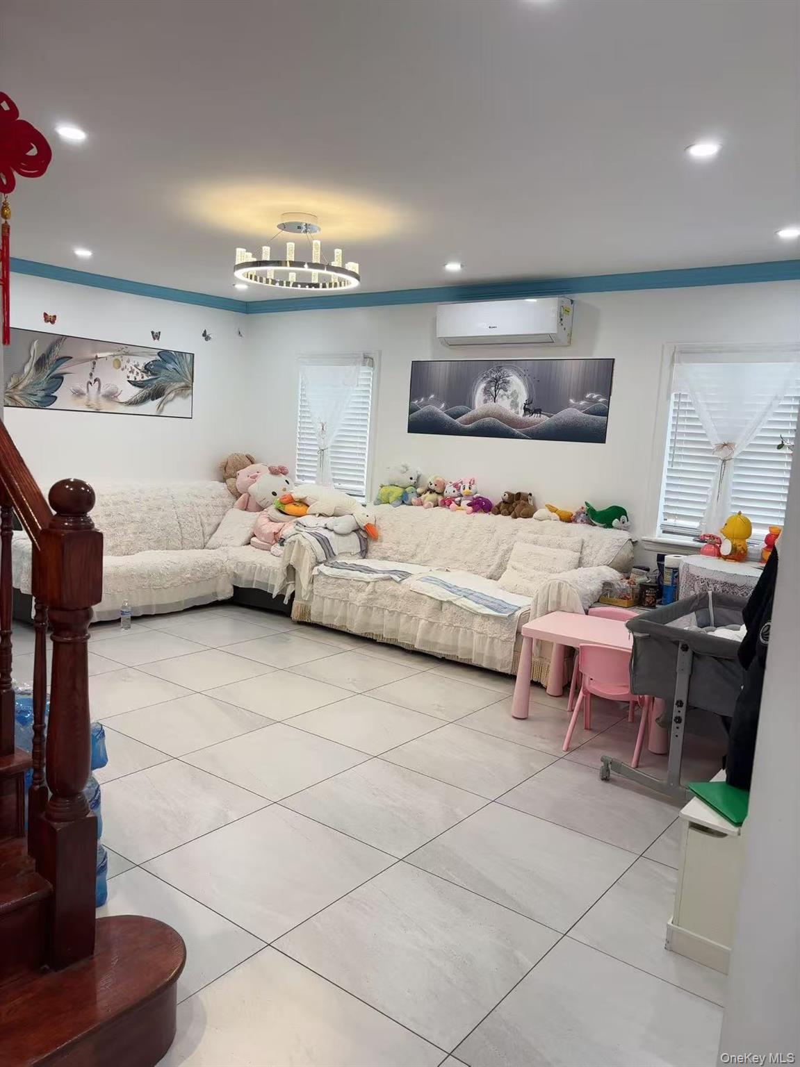 75-47 193rd Street Queens, NY 11366 - Photo 2 of 27 a living room with furniture and a table