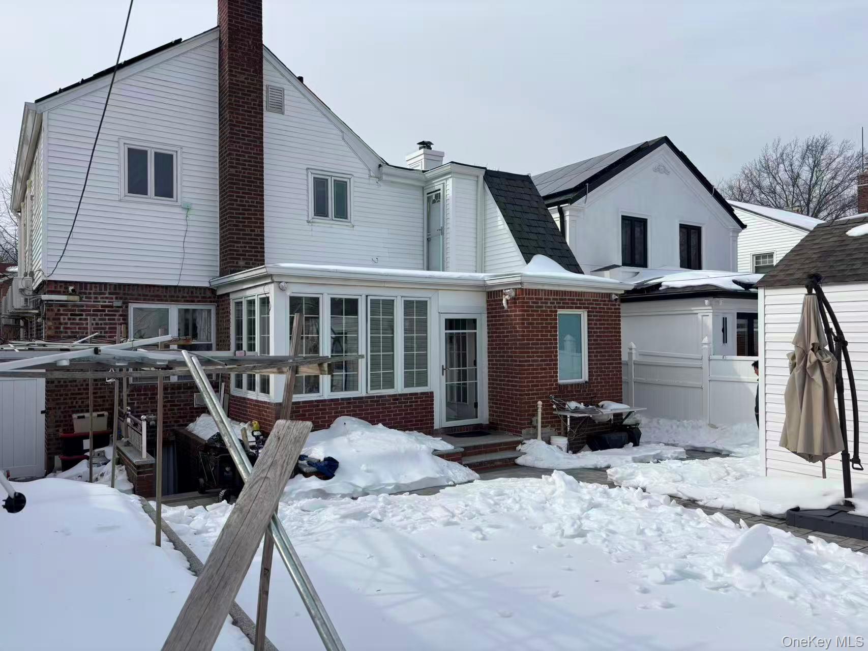 75-47 193rd Street Queens, NY 11366 - Photo 26 of 27 a view of a house with snow on the roof