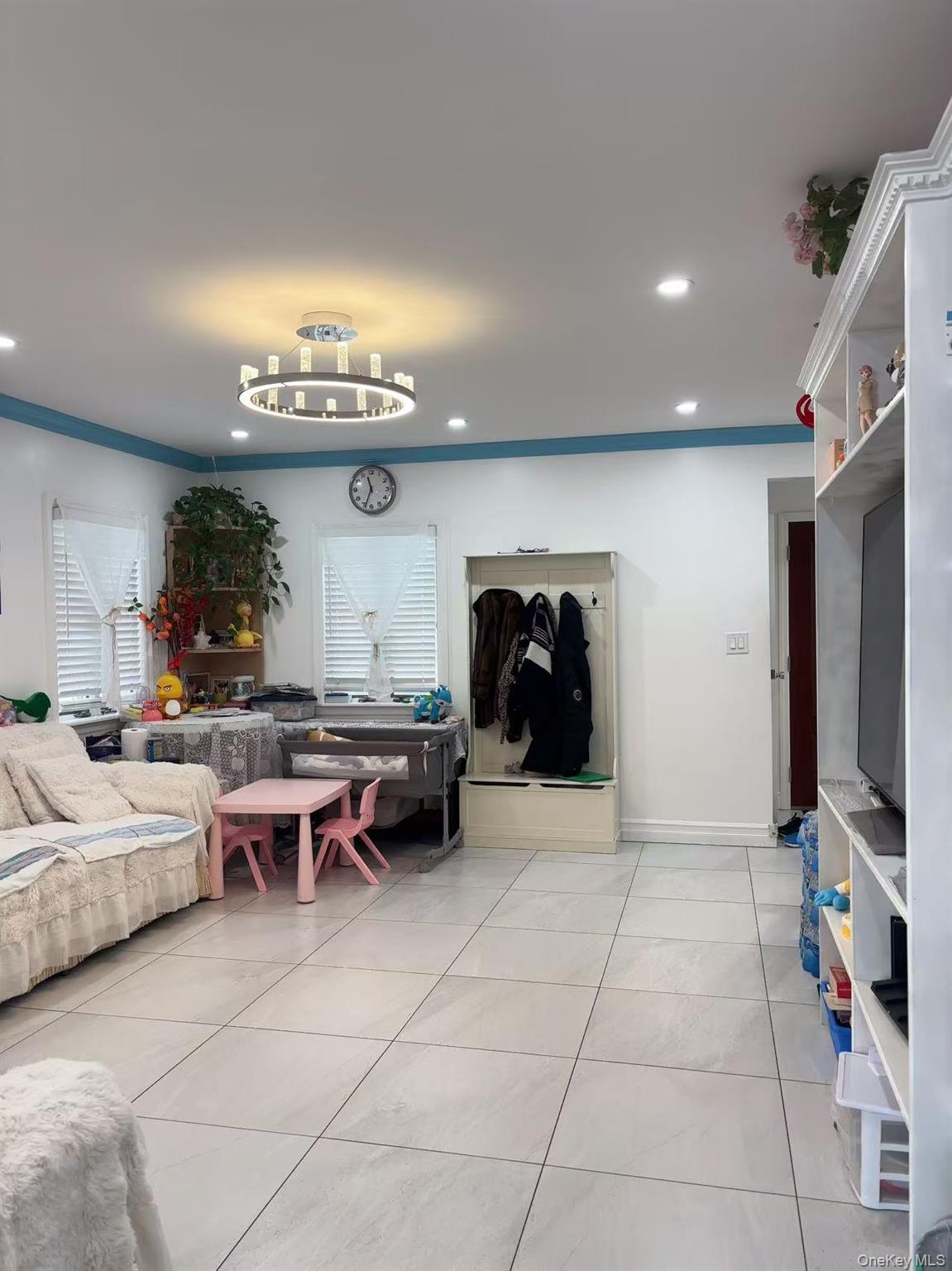 75-47 193rd Street Queens, NY 11366 - Photo 3 of 27 a living room with furniture a dining table and a fireplace