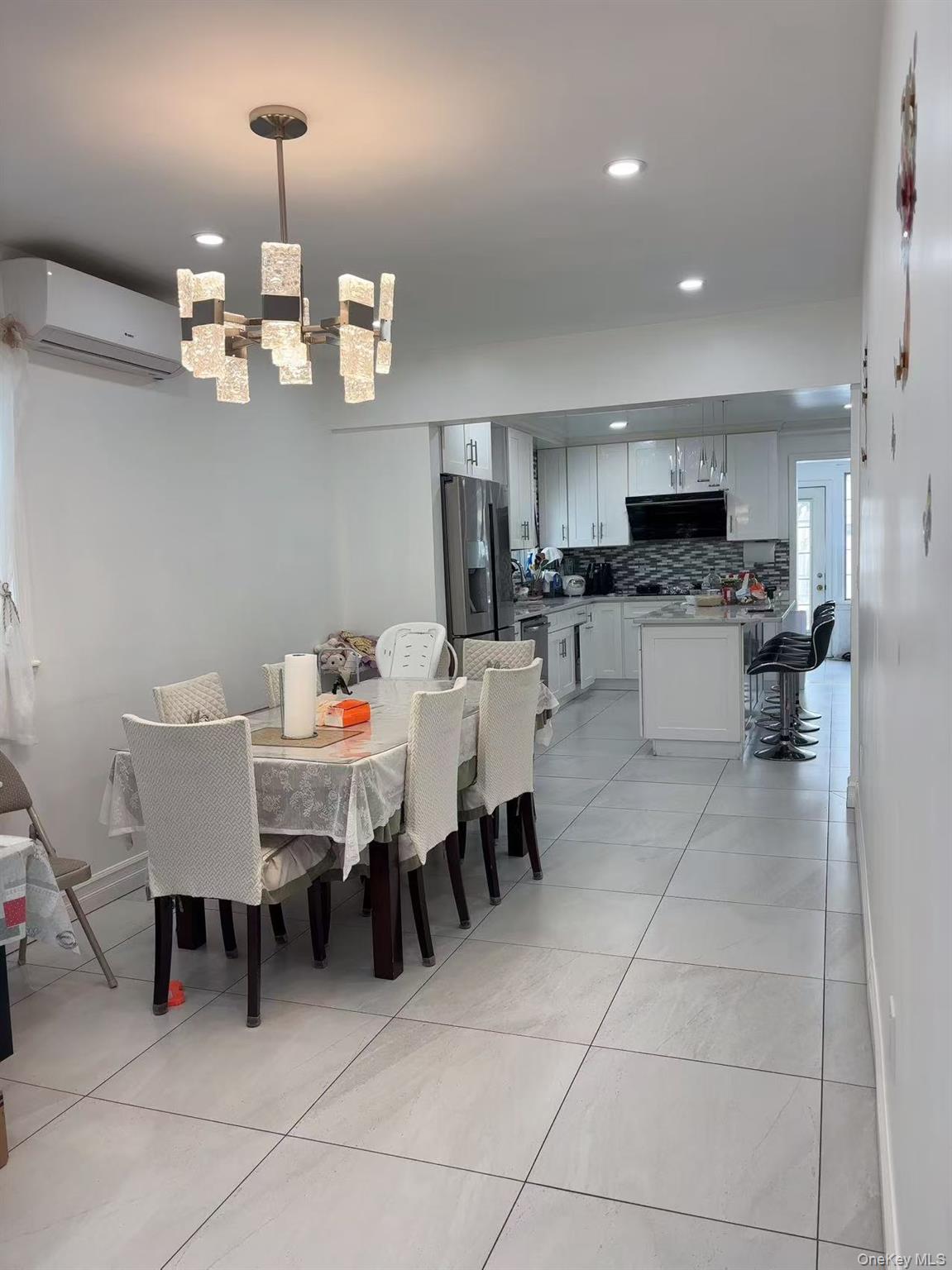 75-47 193rd Street Queens, NY 11366 - Photo 5 of 27 a view of a dining room with furniture and chandelier
