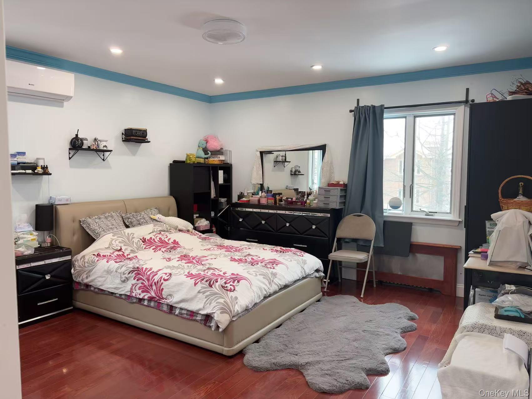 75-47 193rd Street Queens, NY 11366 - Photo 7 of 27 a bedroom with a bed and a furniture