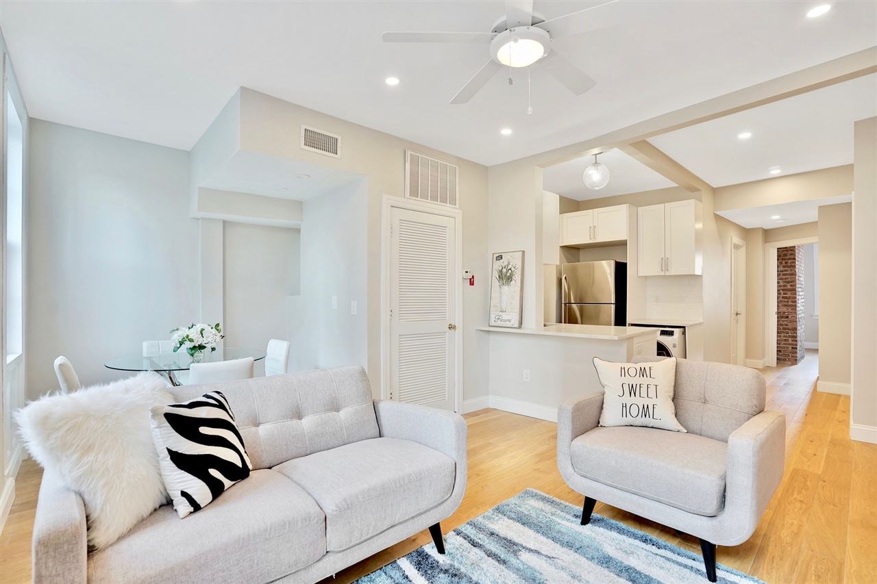 709 Monroe Street, Unit 2 Hoboken, NJ 07030 - Photo 1 of 1 a living room with furniture or couch and a rug