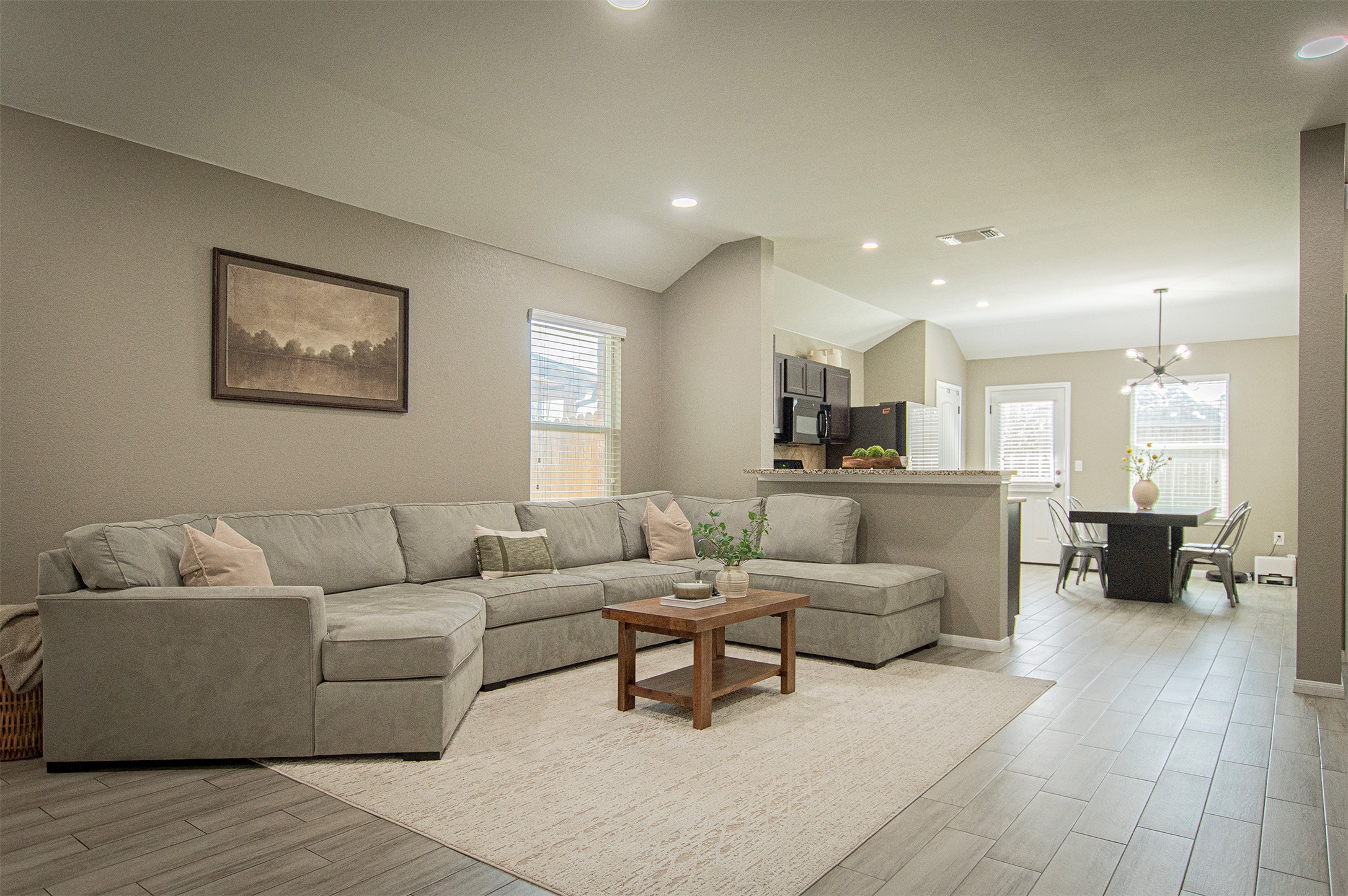 3513 Ortman Drive Pflugerville, TX 78660 - Photo 4 of 17 a living room with furniture and a dining table with wooden floor